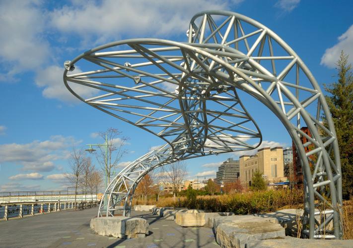 A largescale, outdoor sculpture made of galvanized steel shaped into organic curves. 