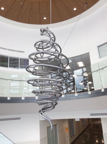 Steel creates a spiraling vortex in this 14-foot sculpture suspended with cables from the ceiling. 