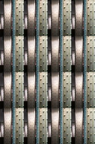 Photograph of concrete strips dotted with rivets.